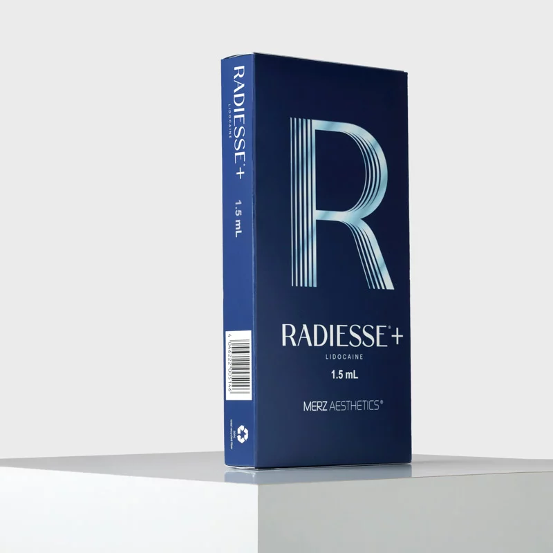 Dark blue Radiesse+ Lidocaine 1.5 mL box from Merz Aesthetics on a white platform.