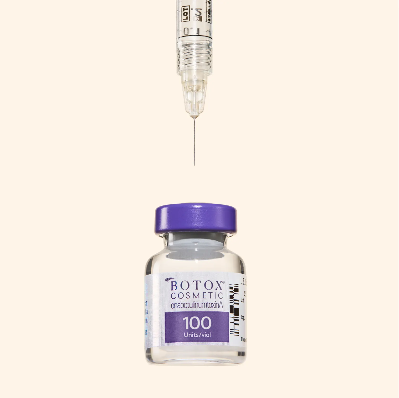 Syringe needle positioned above a 100-unit vial of Botox Cosmetic with a purple cap.