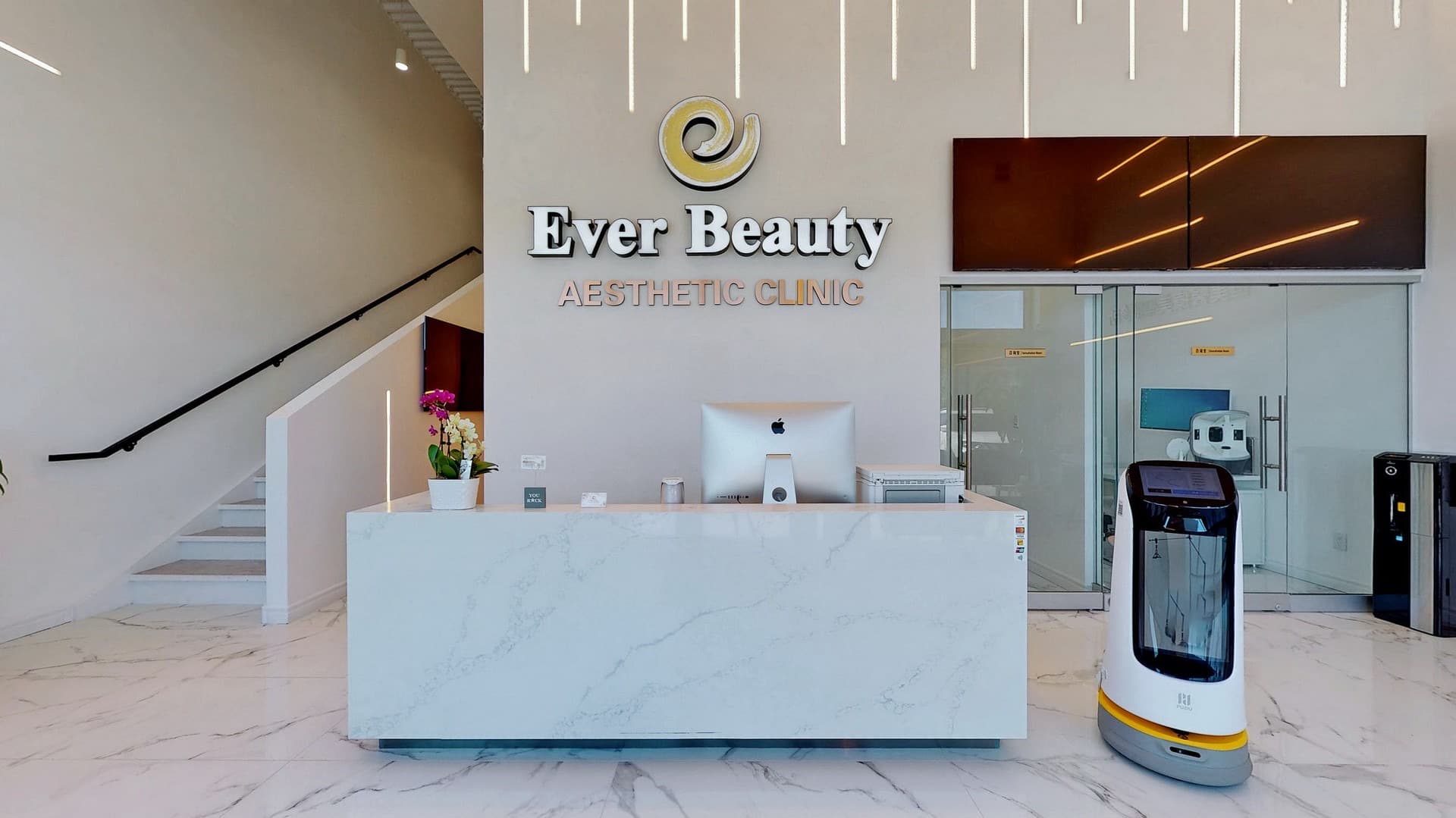 Ever Beauty Aesthetic Clinic reception area featuring a marble desk and a white service robot.