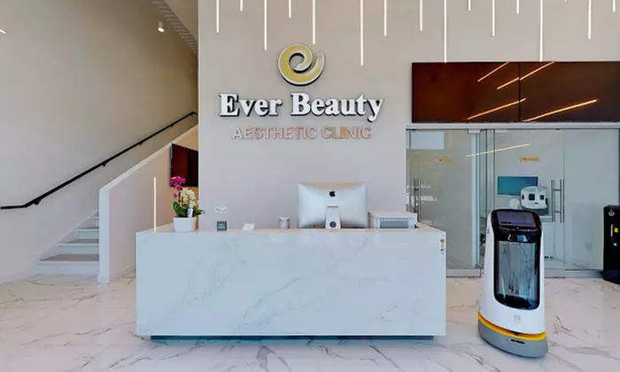 Modern Ever Beauty Aesthetic Clinic reception featuring a white marble desk and a service robot.